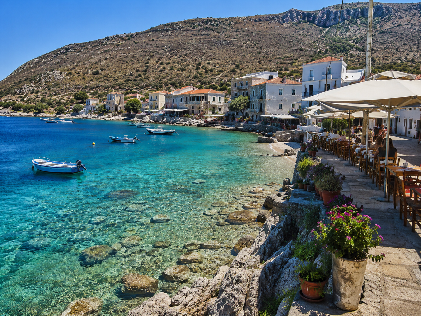 Stone houses and fishing boats in the turquoise bay of Limeni, Mani Peninsula, Greece